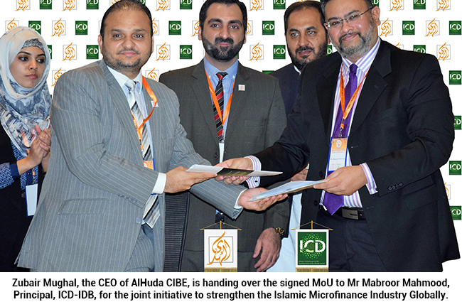 Zubair Mughal, the CEO of AlHuda CIBE, is handing over the signed MoU to Mr Mabroor Mahmood, Principal, ICD-IDB, for the joint initiative to strengthen the Islamic Microfinance Industry Globally.